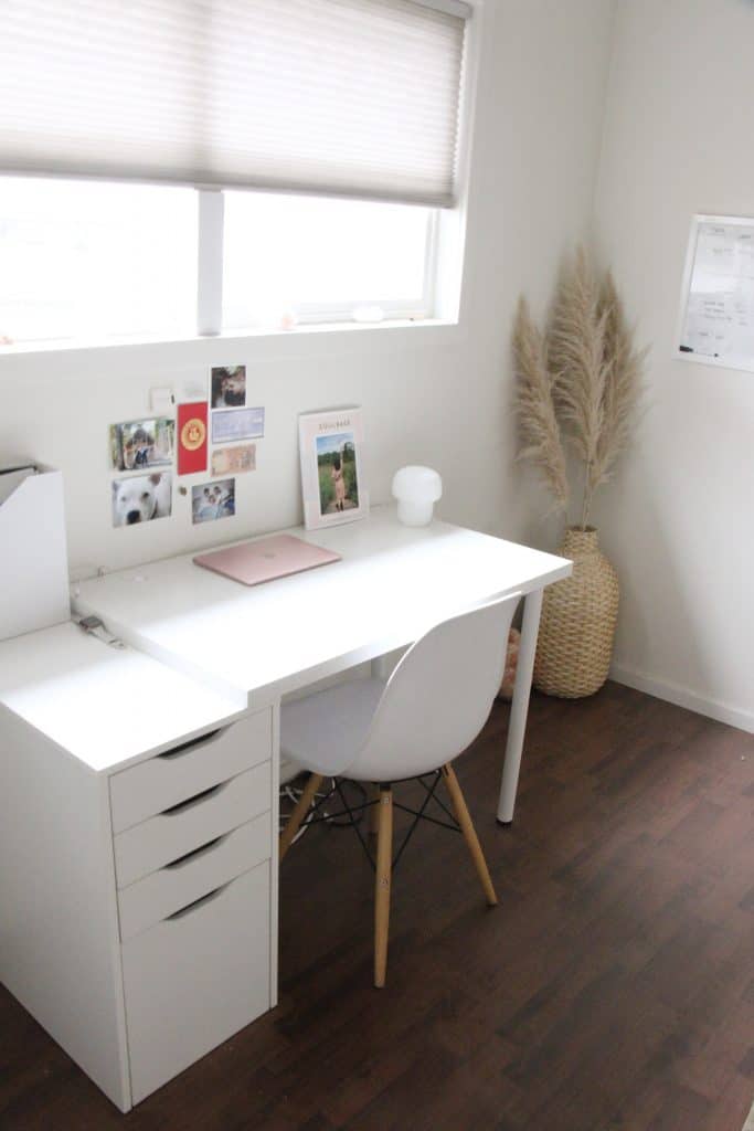 Image of white desk at angle showing photo under window sill