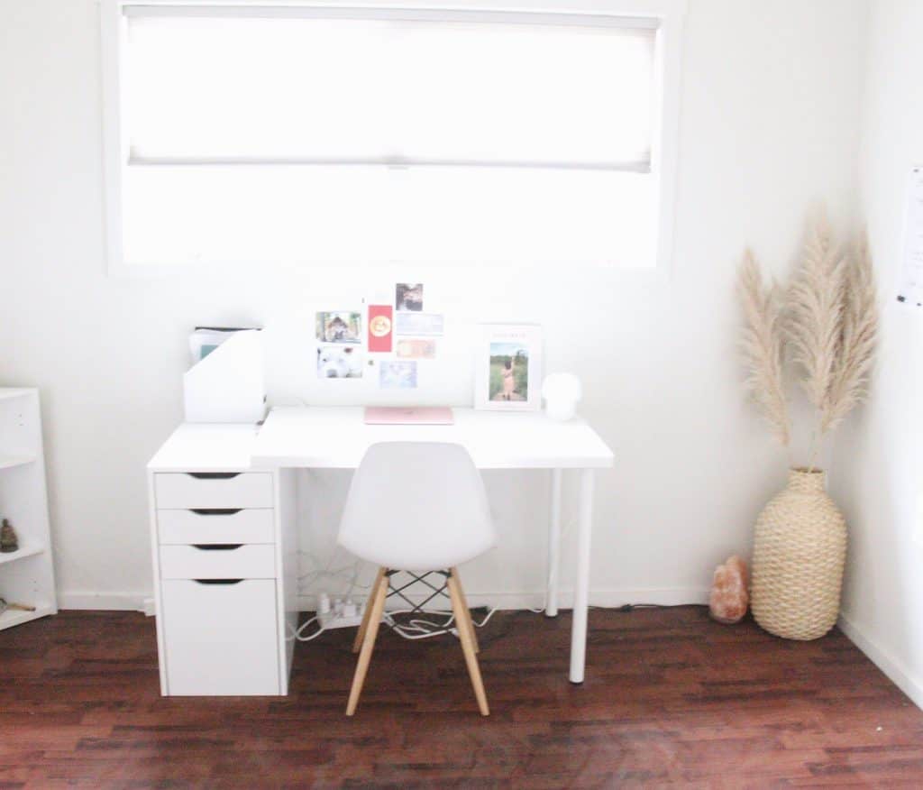 white desk in front of large bright window