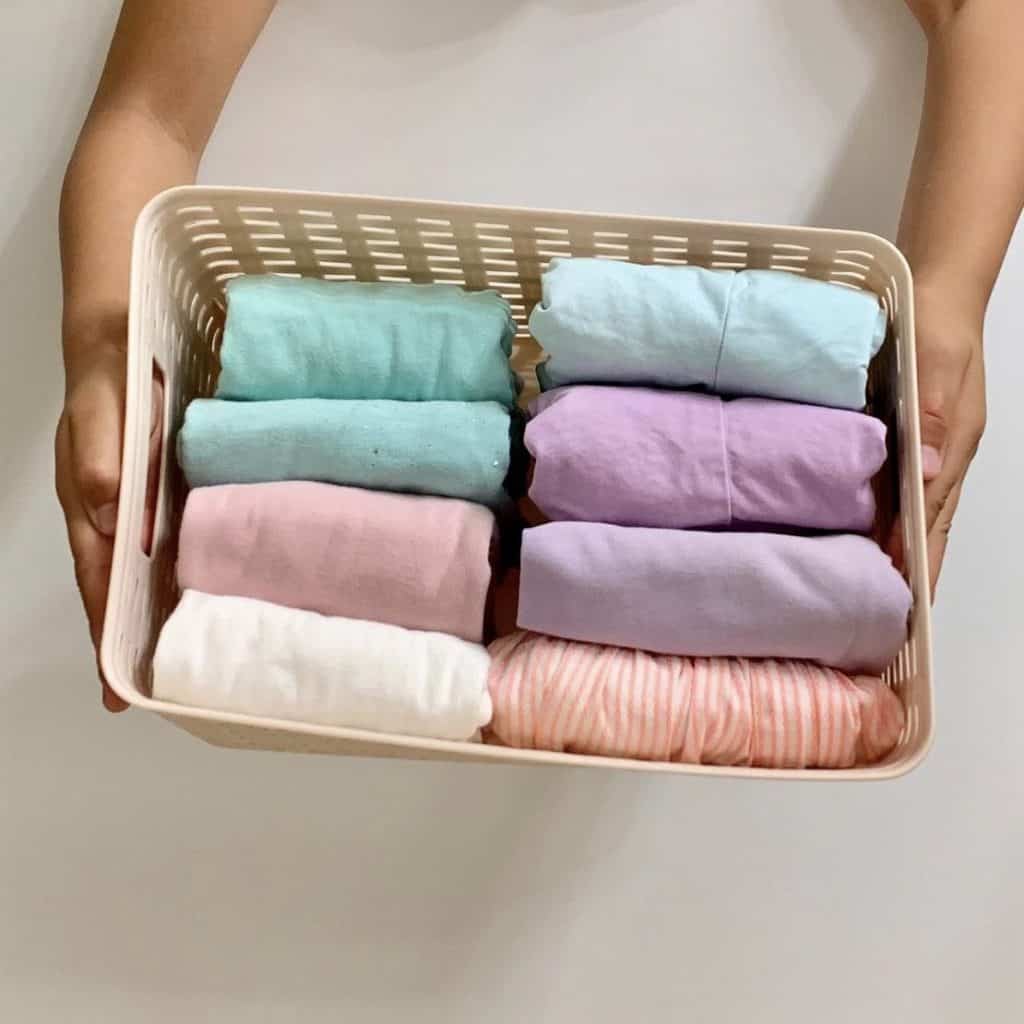 File folding with kids clothing in pink container for organization