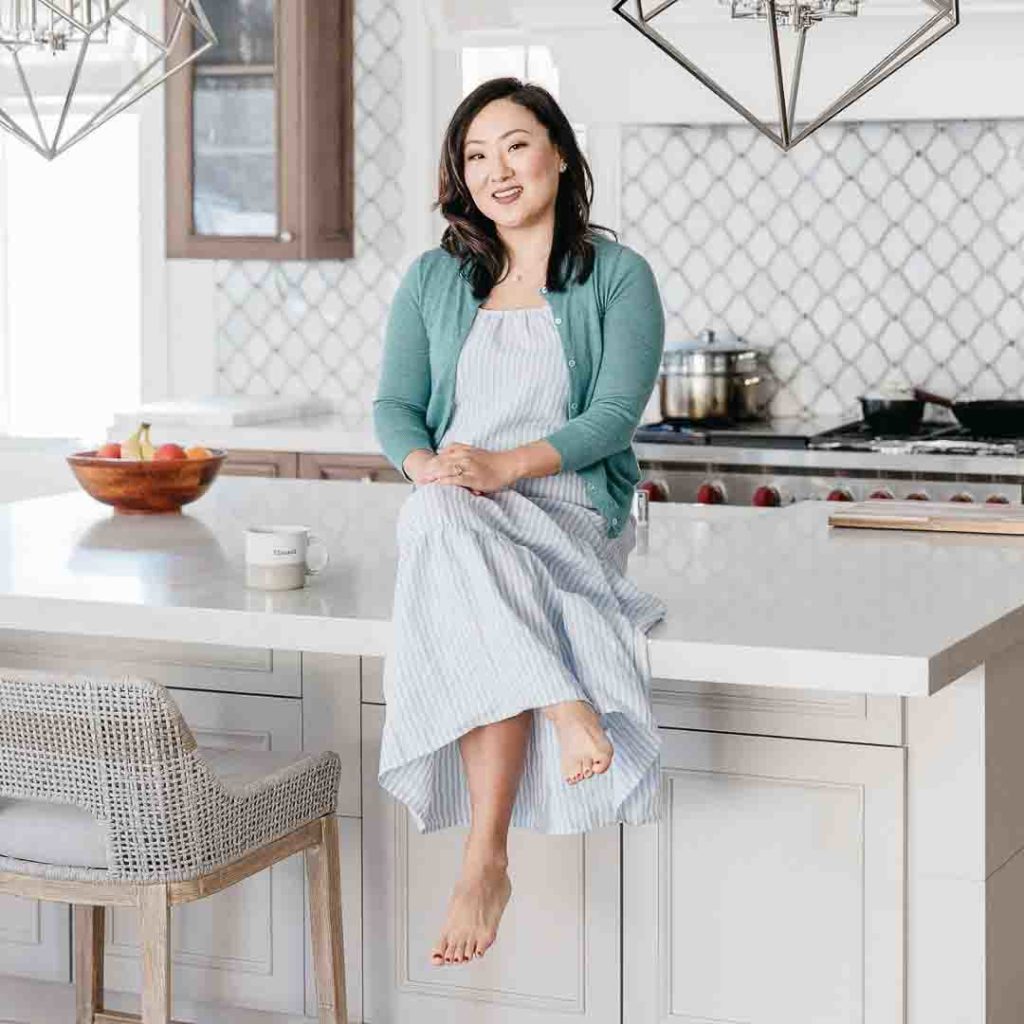 woman seated on kitchen island sandy park tidy with spark