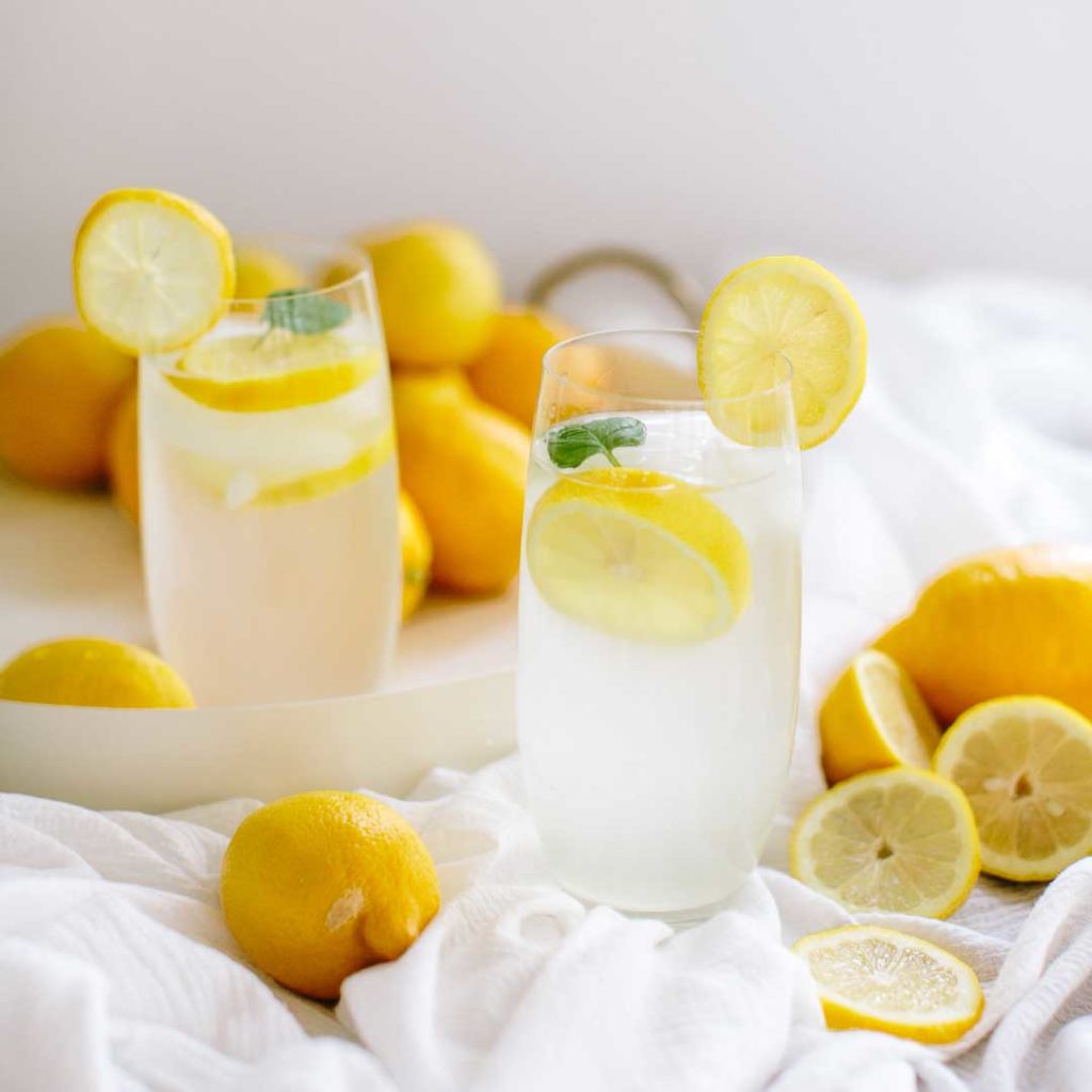 lemonade and lemons on a table top