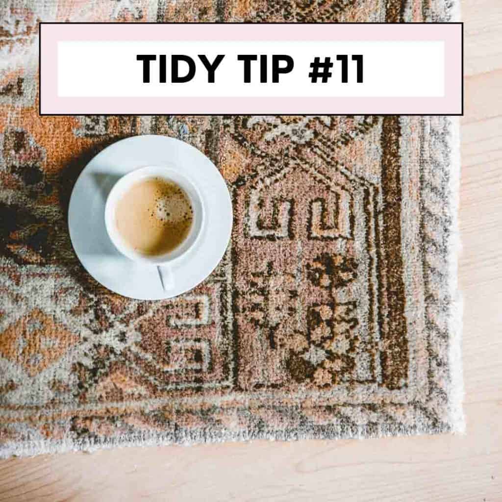 coffee in cup and saucer on top of brown tribal rug