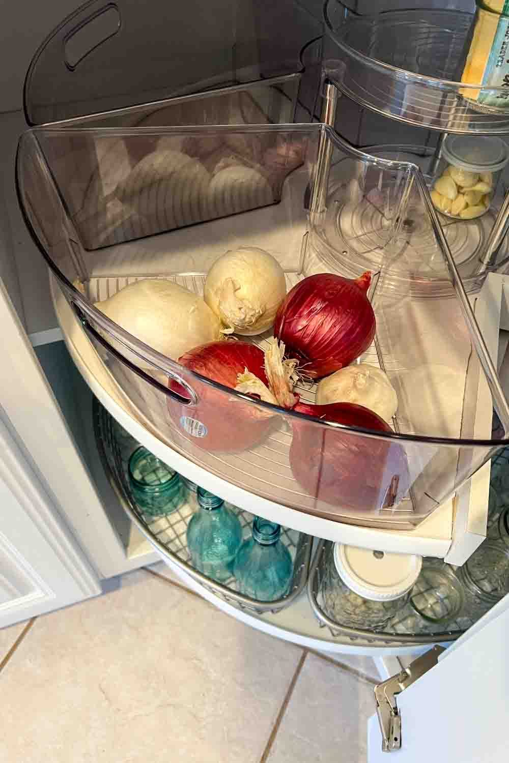 onions and garlic stored in triangle organizing bin