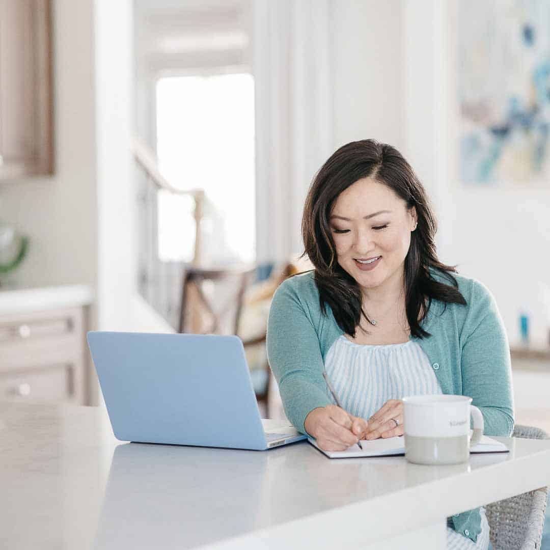 Sandy Park Tidy with SPARK seated at kitchen writing in journal