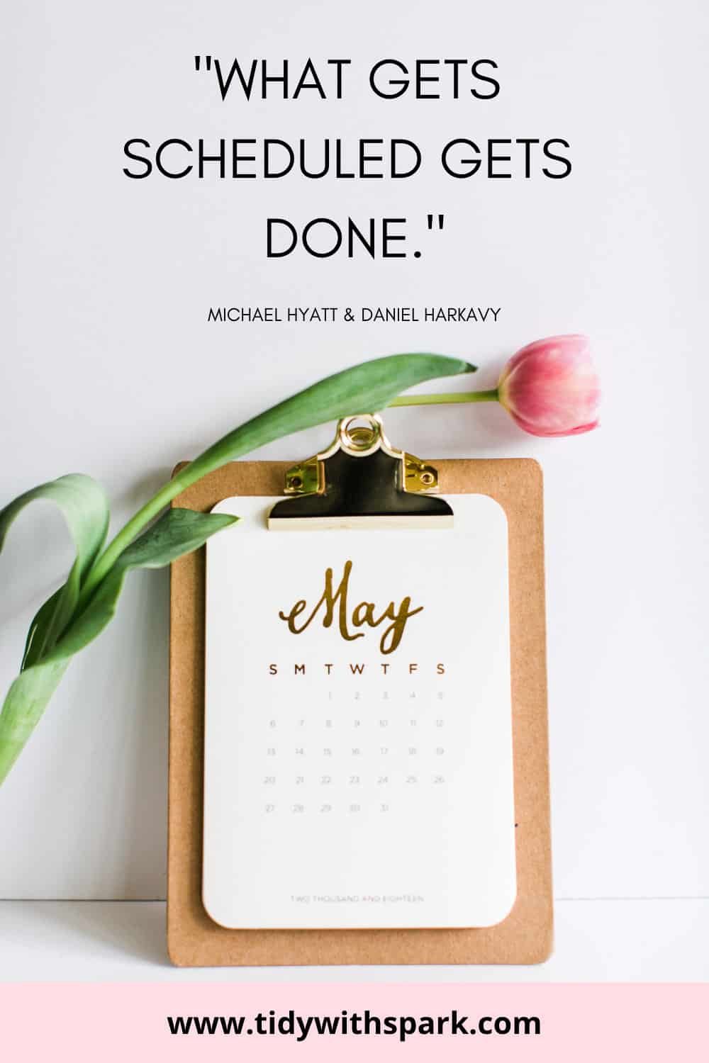 Clipboard with calendar and pink tulip laid on top with text overlay "what gets scheduled gets done"